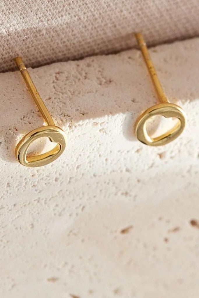 close up of the gold cut out love heart stud earrings