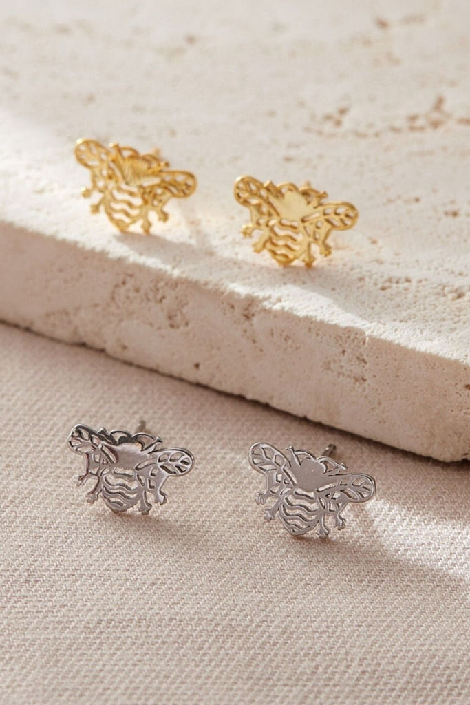 silver and gold coloured bee stud earrings, the earrings are designed in an open work style 