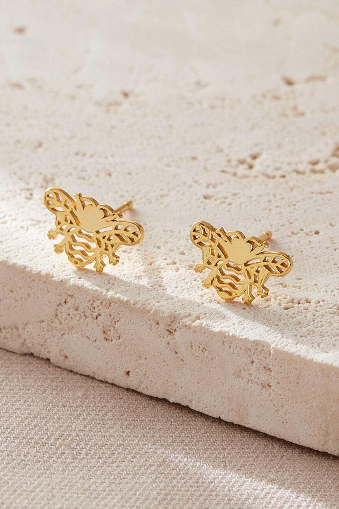close up of the gold openwork bee stud earrings