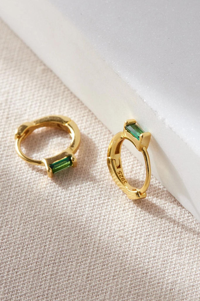 close up of the green cz gold dangle hoop earrings