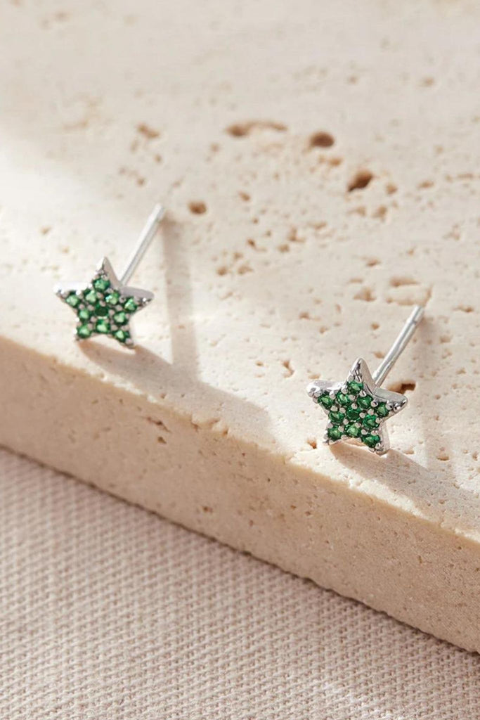 close up of the green, may, star stud earrings