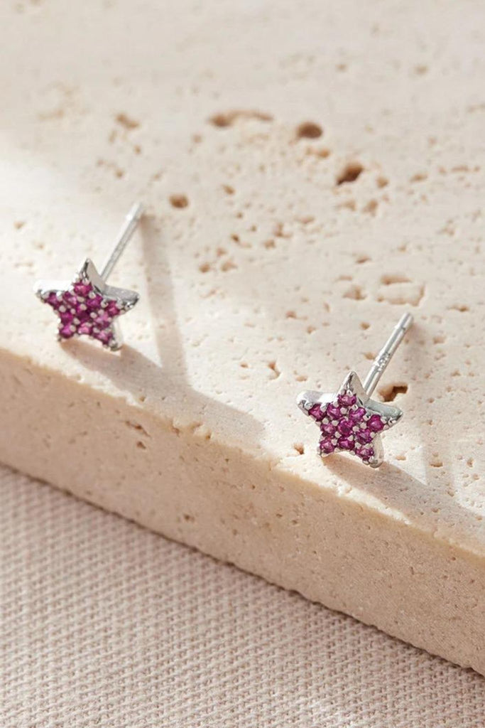 close up of the pink, july, star stud earrings