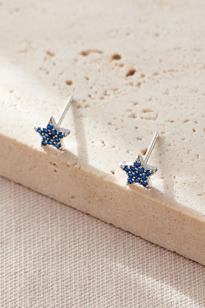 close up of the blue, december, star stud earrings