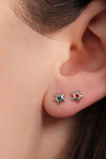 model wearing two colours of the silver birthstone crystal stud earrings, showing the dainty size of the studs