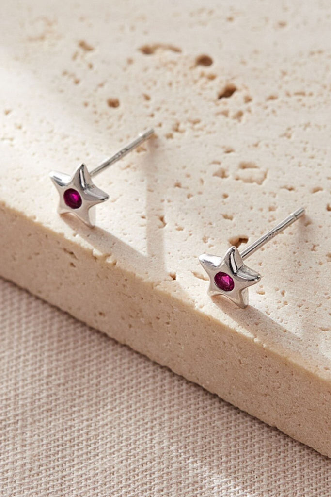 close up of the pink, july cz star stud earrings