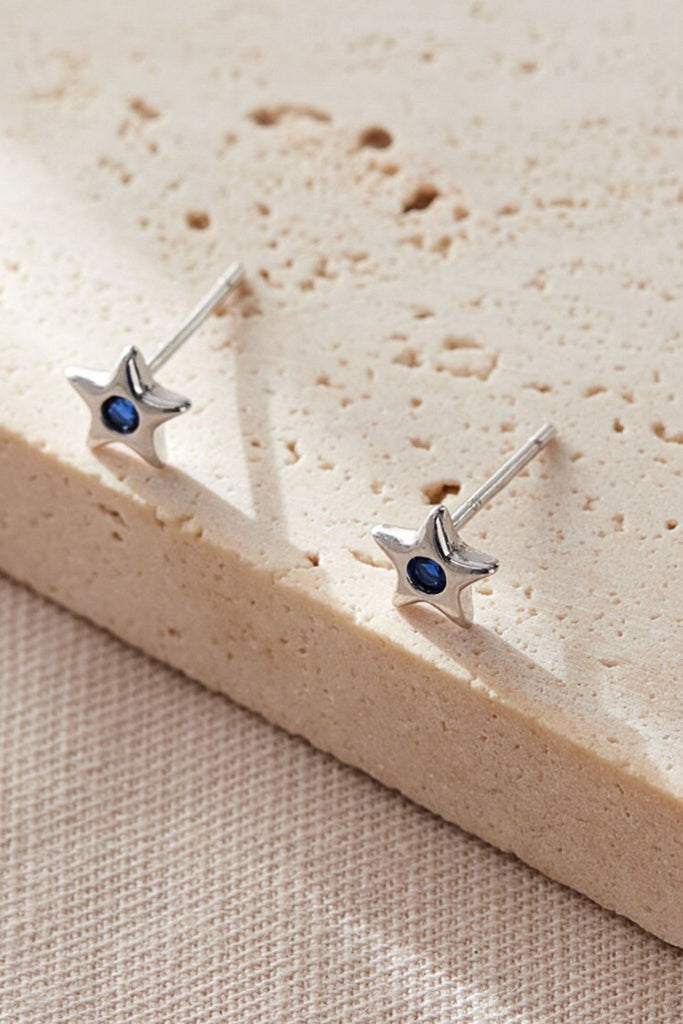 close up of the blue, september star stud earrings