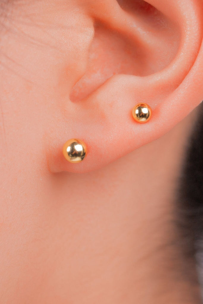 model wearing two of the larger sized of studs