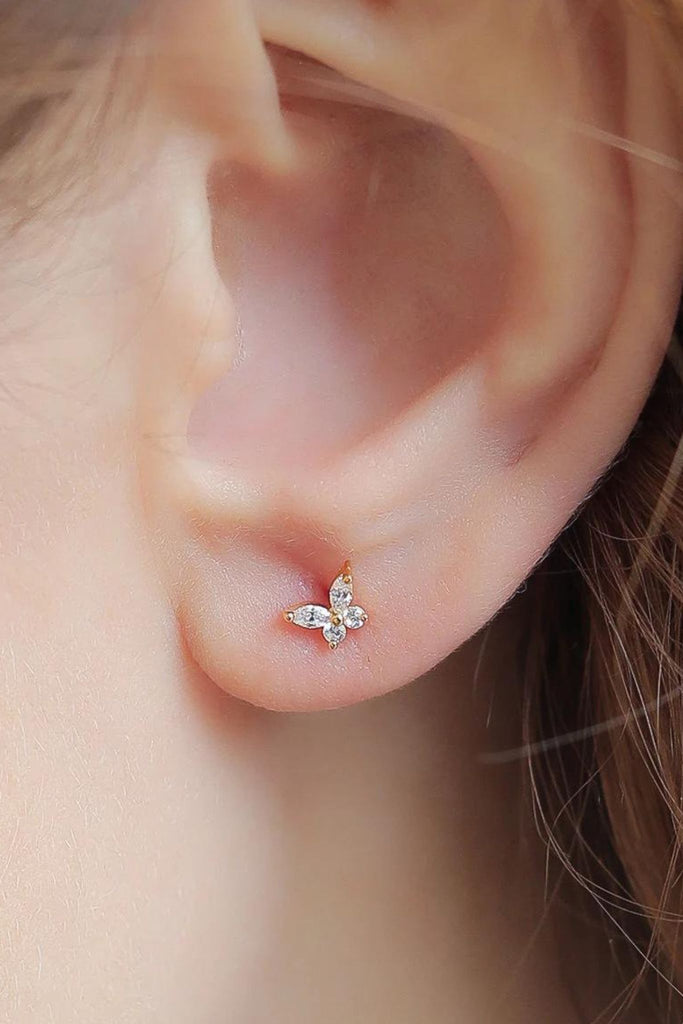 model wearing a small gold cz sparkly stud earring on the earlobe