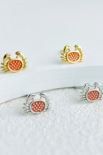 silver and gold coloured s925 crab stud earrings, the crabs have burnt orange middles