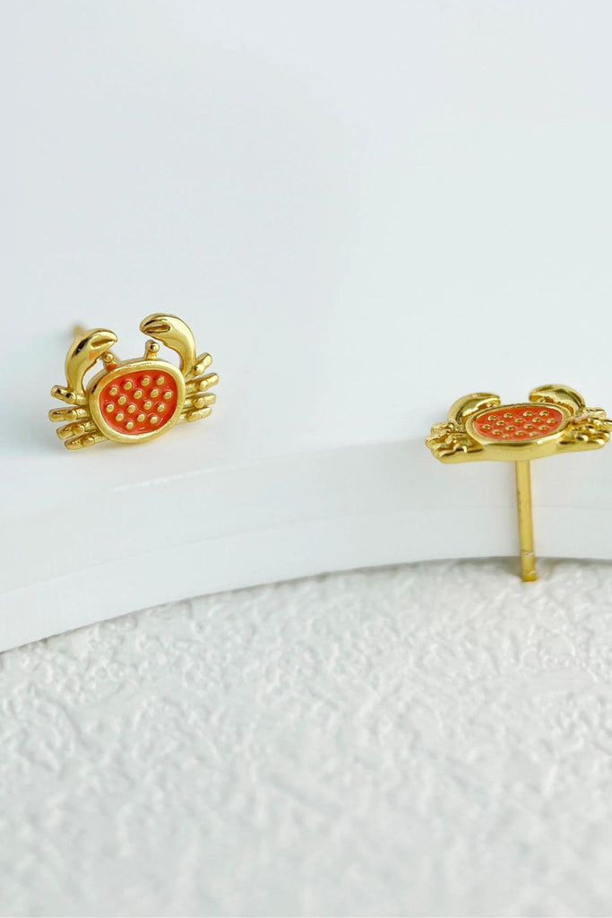 close up of the gold crab stud earrings