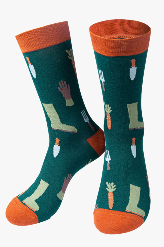 green dress socks with a pattern of garden tools, garden gloves and boots