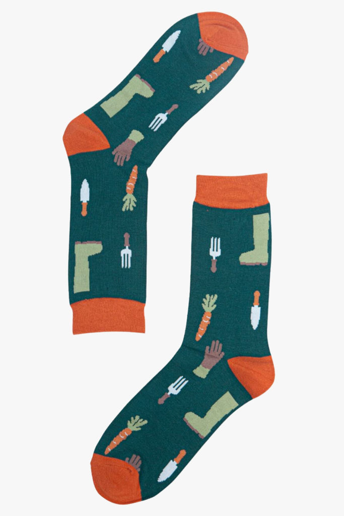 green, orange bamboo socks with gardening tools, carrots, gloves and boots