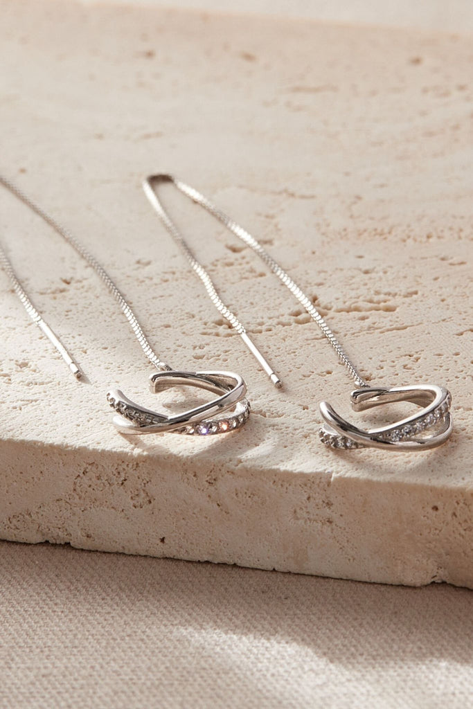 showing a close up of one pair of these silver and cz sparkly cuff chain earrings,