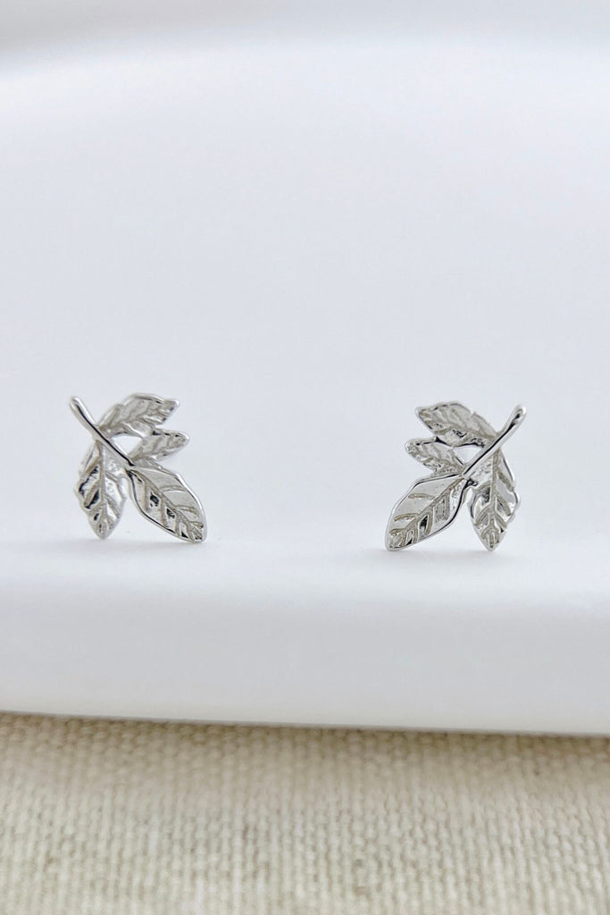 close up of the silver leaves stud earrings, showing the intricate design of the leaves