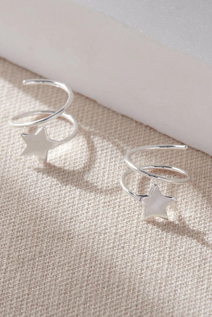 close up of the silver coloured s925 sterling silver star climber earrings