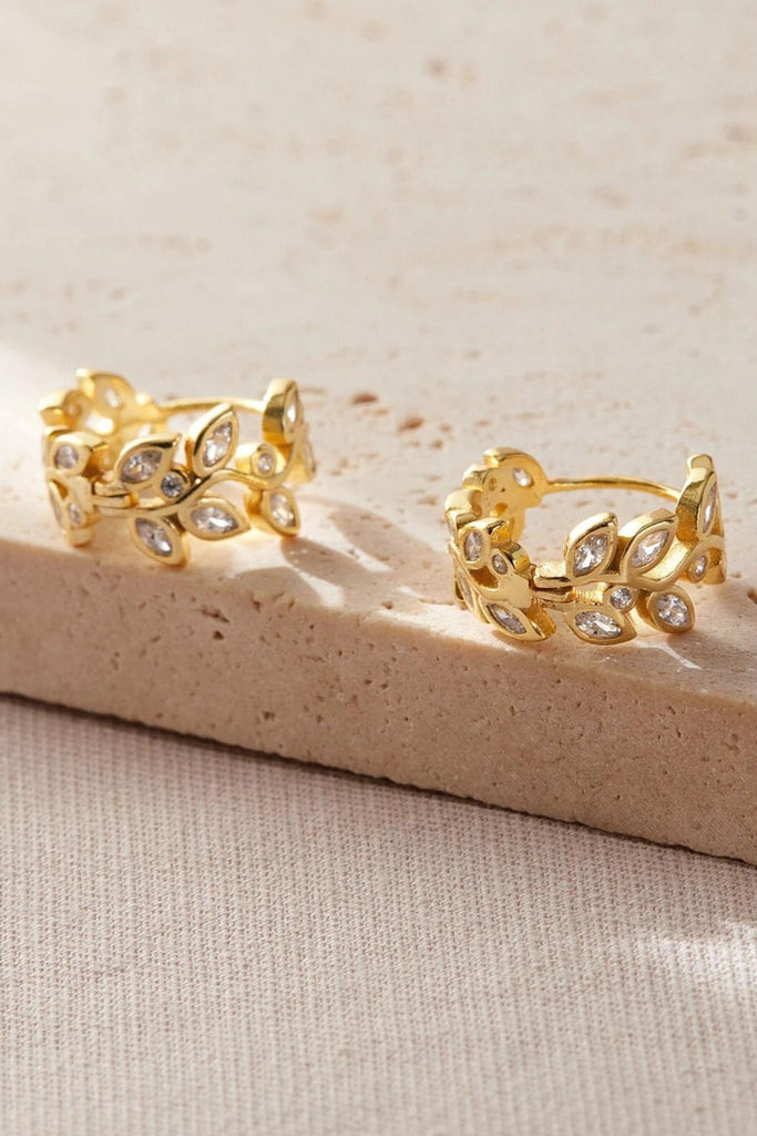 close up of the gold plated silver sparkly olive leaf hoops