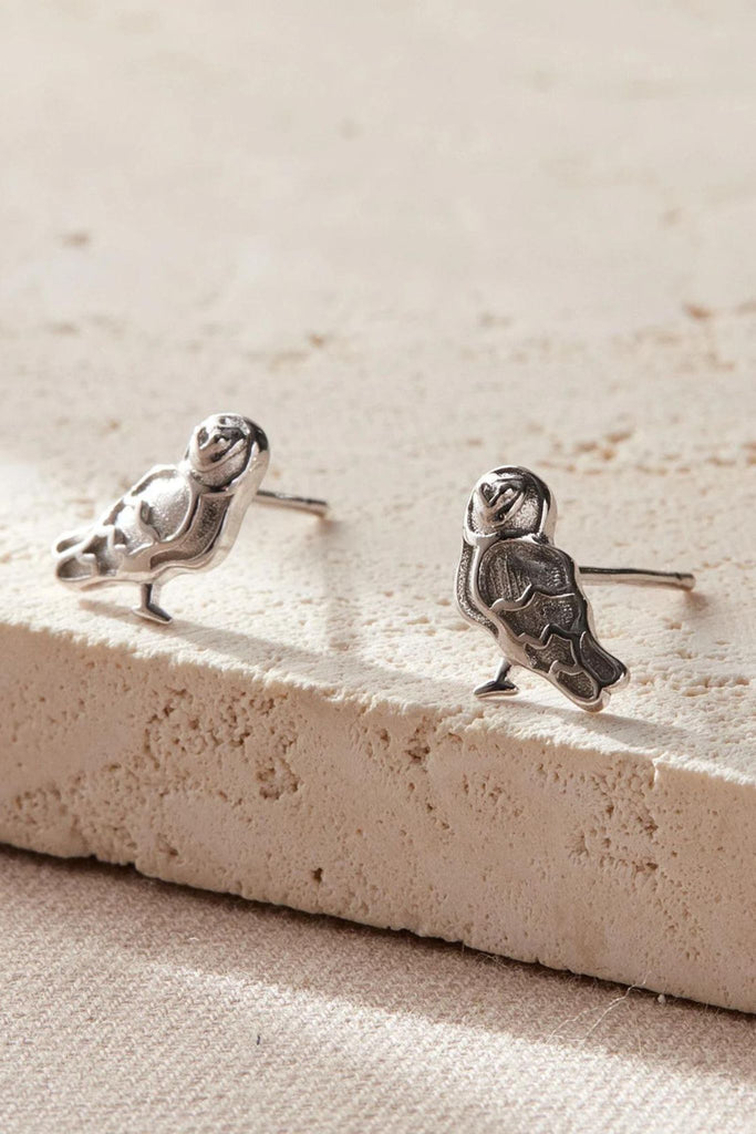 a pair of silver barn owl stud earrings