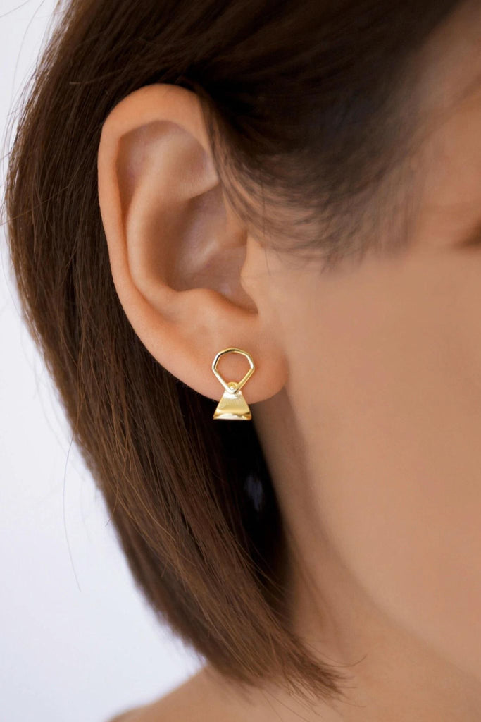 model wearing a gold ring pull stud earring