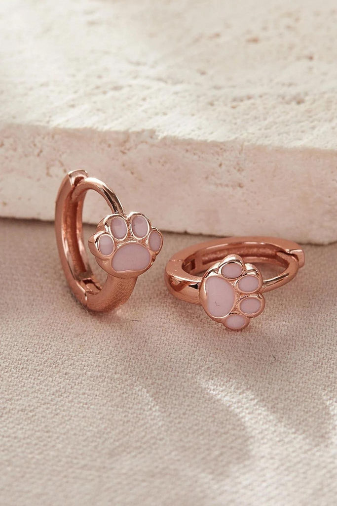 close up of the rose gold dog paw hoop earrings