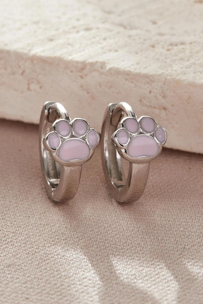 close up of the silver dog paw hoop earrings