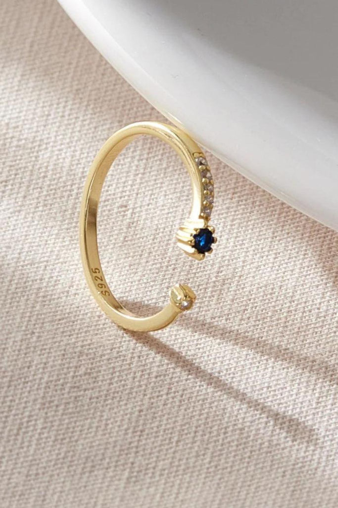 close up of the inner rim of the ring, showing the s925 stamp and a clear view of the minimal cz stones on the outer rim