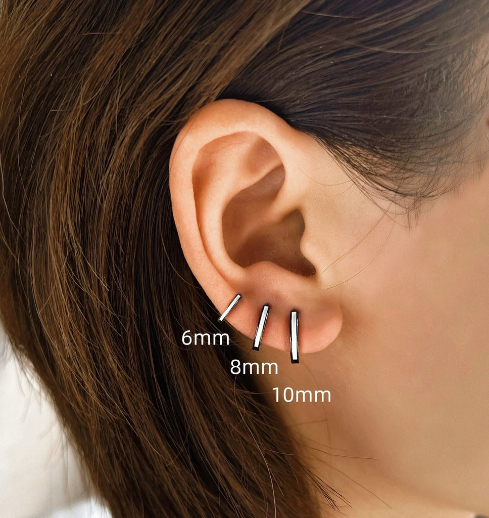 model wearing all three sizes of the black and white s999 sterling silver huggie hoop earrings