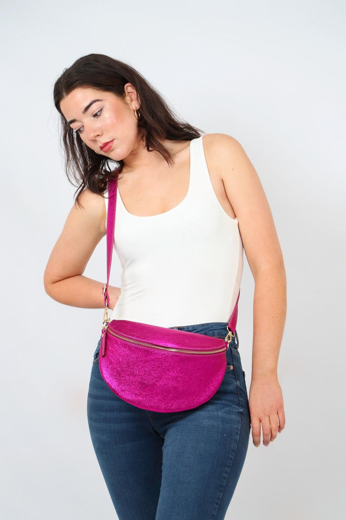 model wearing a large pink metallic leather crossbody bag