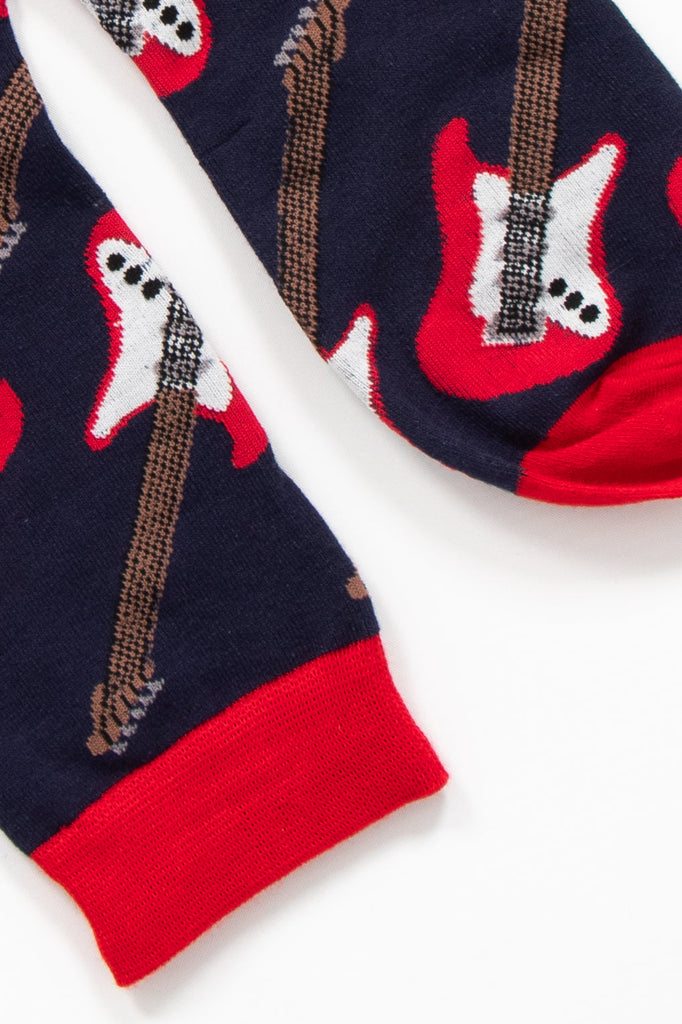 close up of the toe and cuff of the socks, both are red and contrast the navy blue background of the socks