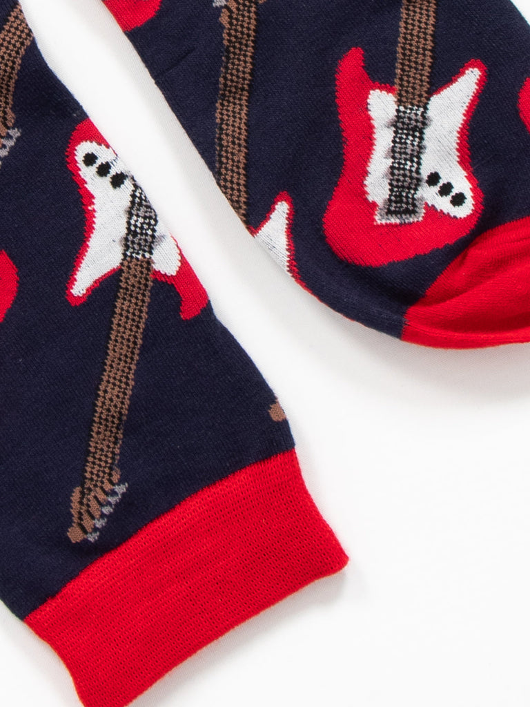 close up of the toe and cuff of the socks, both are red and contrast the navy blue background of the socks