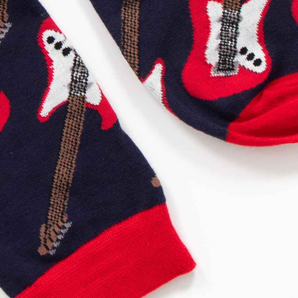 close up of the toe and cuff of the socks, both are red and contrast the navy blue background of the socks