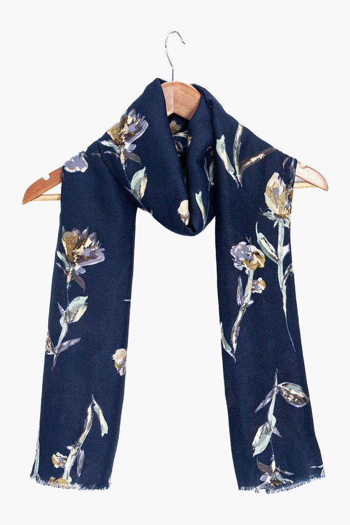 vaeda-navy-blue-floral-lightweight-scarf-draped-on-coat-hanger