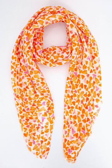 lightweight summer scarf with an all over pattern of orange love hearts which look like they have been hand sketched
