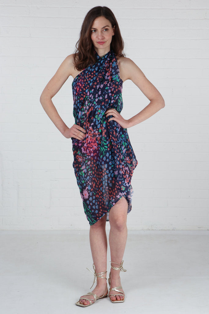model wearing a navy blue floral print scarf as a beach cover up dress
