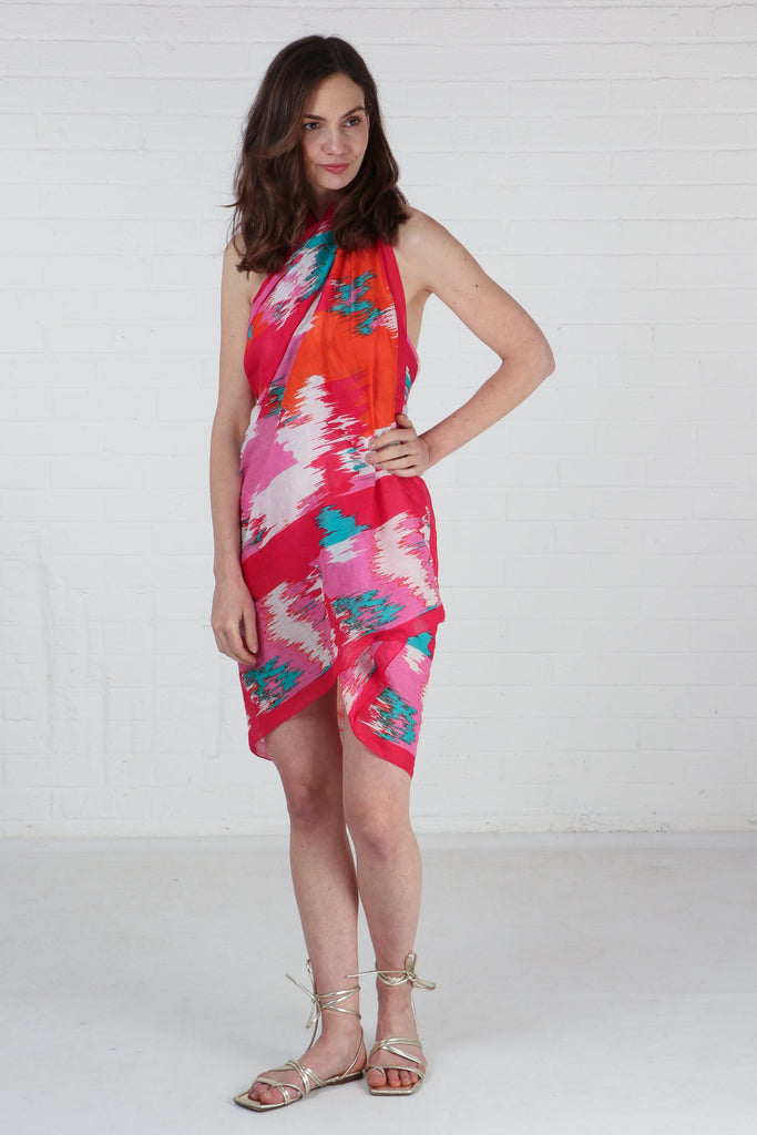 model wearing this pink chevron pattern scarf as a beach coverup dress