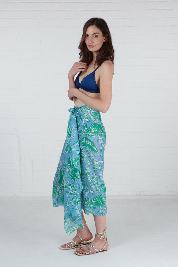 model showing that this floral print scarf can also be worn as a beach coverup sarong