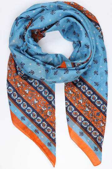 blue and orange ornate floral pattern scarf, the scarf is blue with a contrasting navy blue and orange floral print border