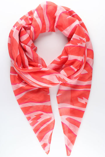 coral zebra print cotton scarf with large pink lightning bolt details throughout the design