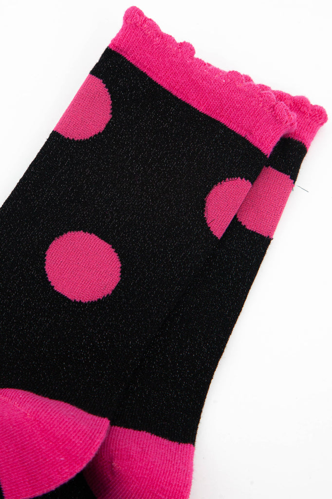 close up of the pink and black glitter socks showing the all over sparkle effect of the material