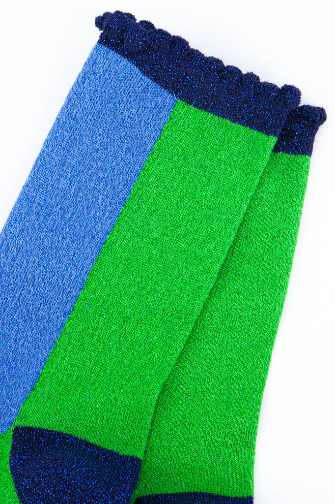 close up of the all over glitter sparkle on these colourful green and blue glitter socks