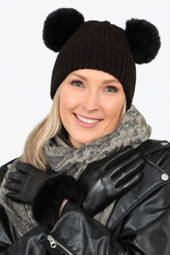 model wearing black vegan leather gloves and matching winter accessories