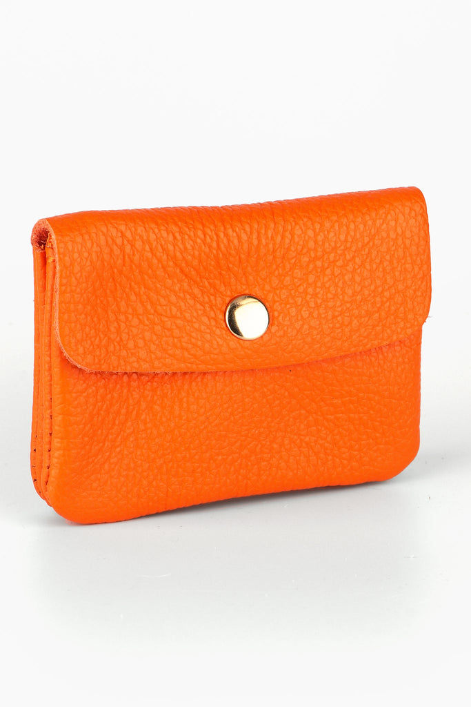 small orange leather coin purse with a snap button fastening