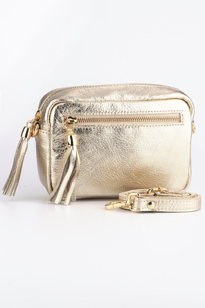 gold leather crossbody camera bag with a front zip pocket and matching detachable bag strap