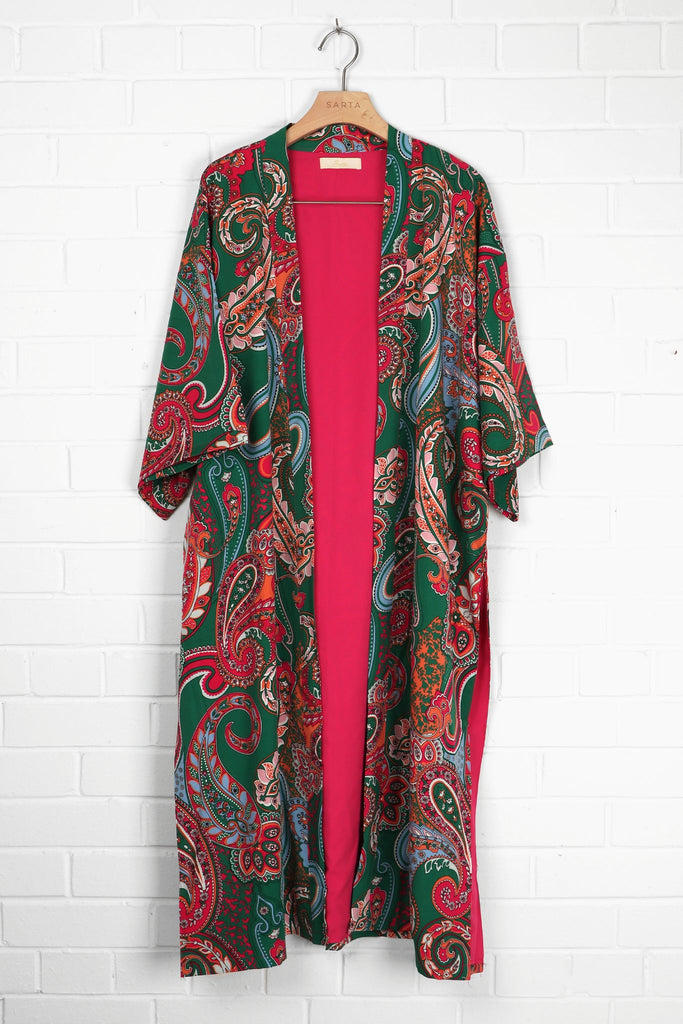 green and pink paisley print kimono hanging on a coat hanger