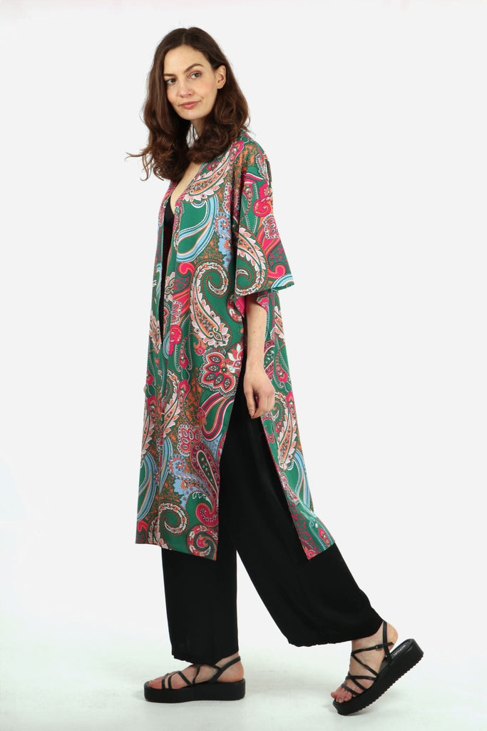 model showing a side view of the mid length green paisley print kimono, showing the side split feature and 3/4 sleeves