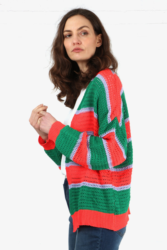 model wearing a long sleeve open front cardigan made from cotton in an open knit design