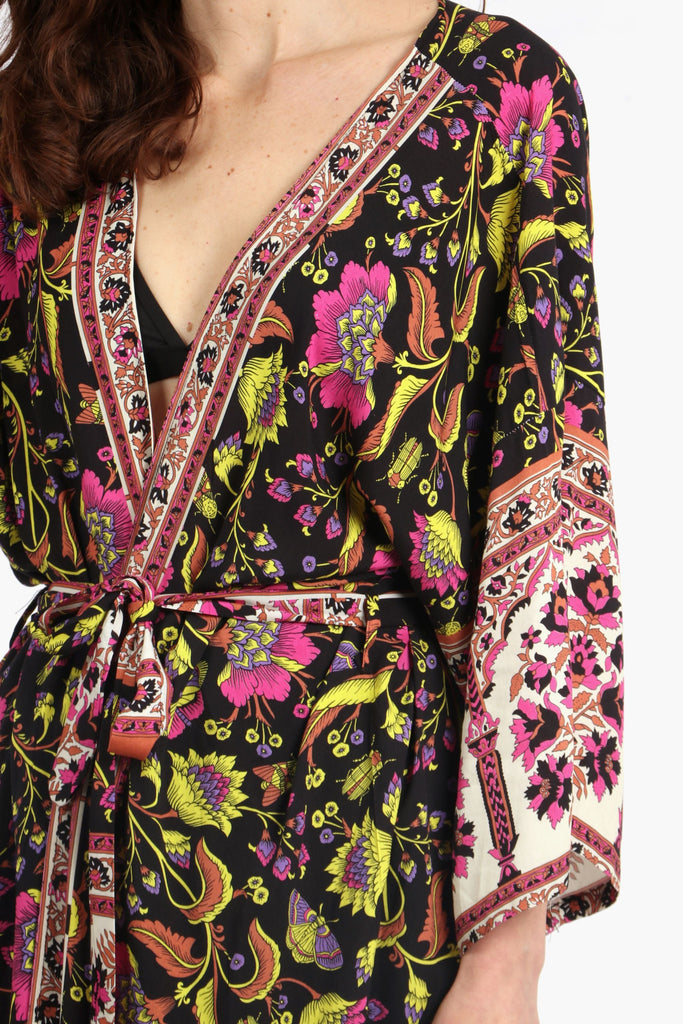 close up of the floral and butterfly pattern on the kimono robe, showing the border trim detail around the edges and the waist tie fastening