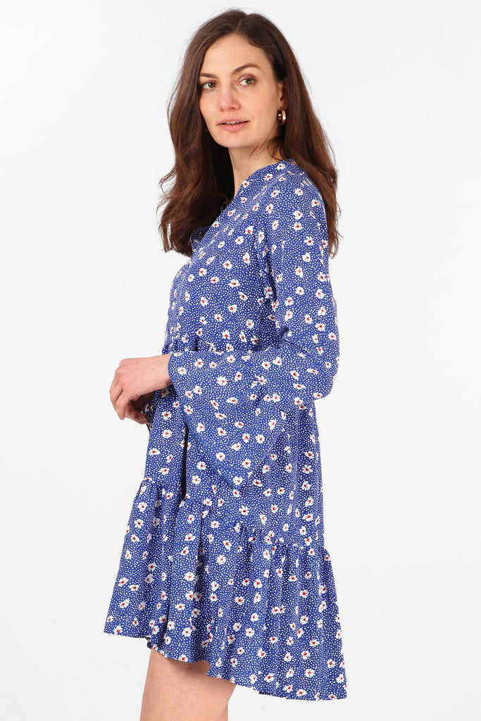 side view of the blue mini dress showing the fluted sleeves and short hemline