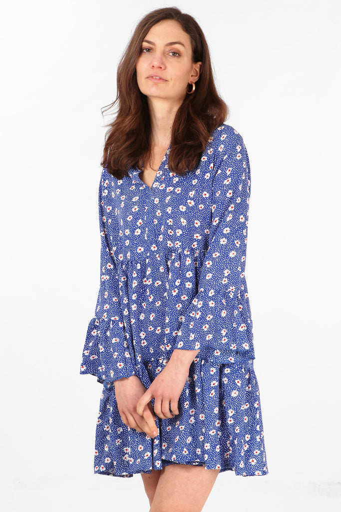 blue daisy print mini dress with long fluted sleeves and a tiered hem