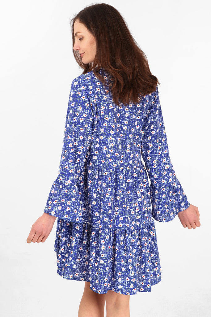 model showing the back of the dress, showing an all over floral and spot print pattern