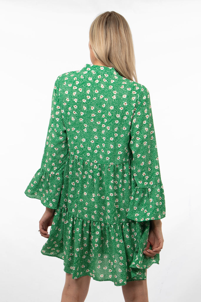 model showing the back of the dress with the all over daisy print pattern